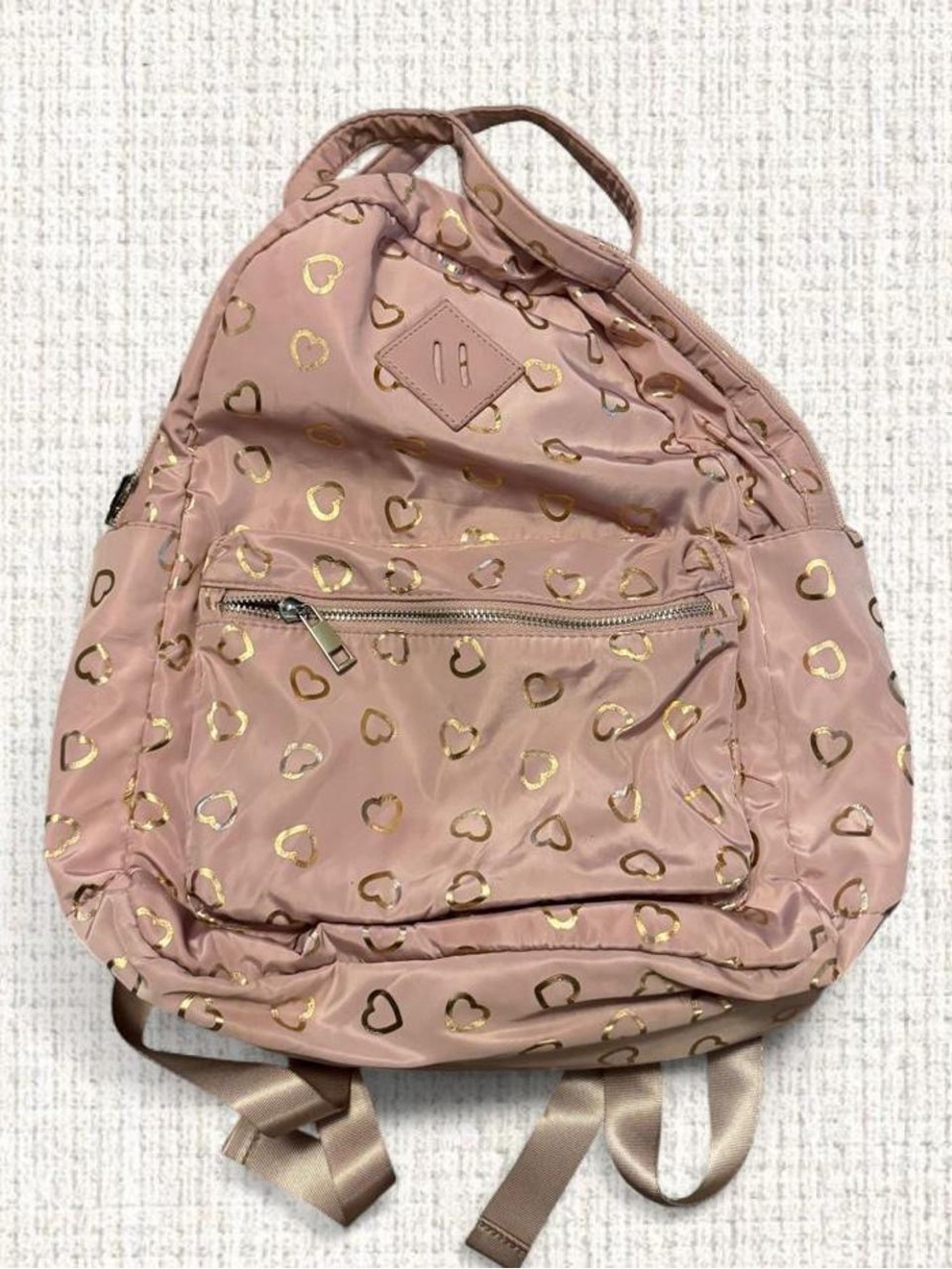 Blush pink backpack with metallic gold heart print.
